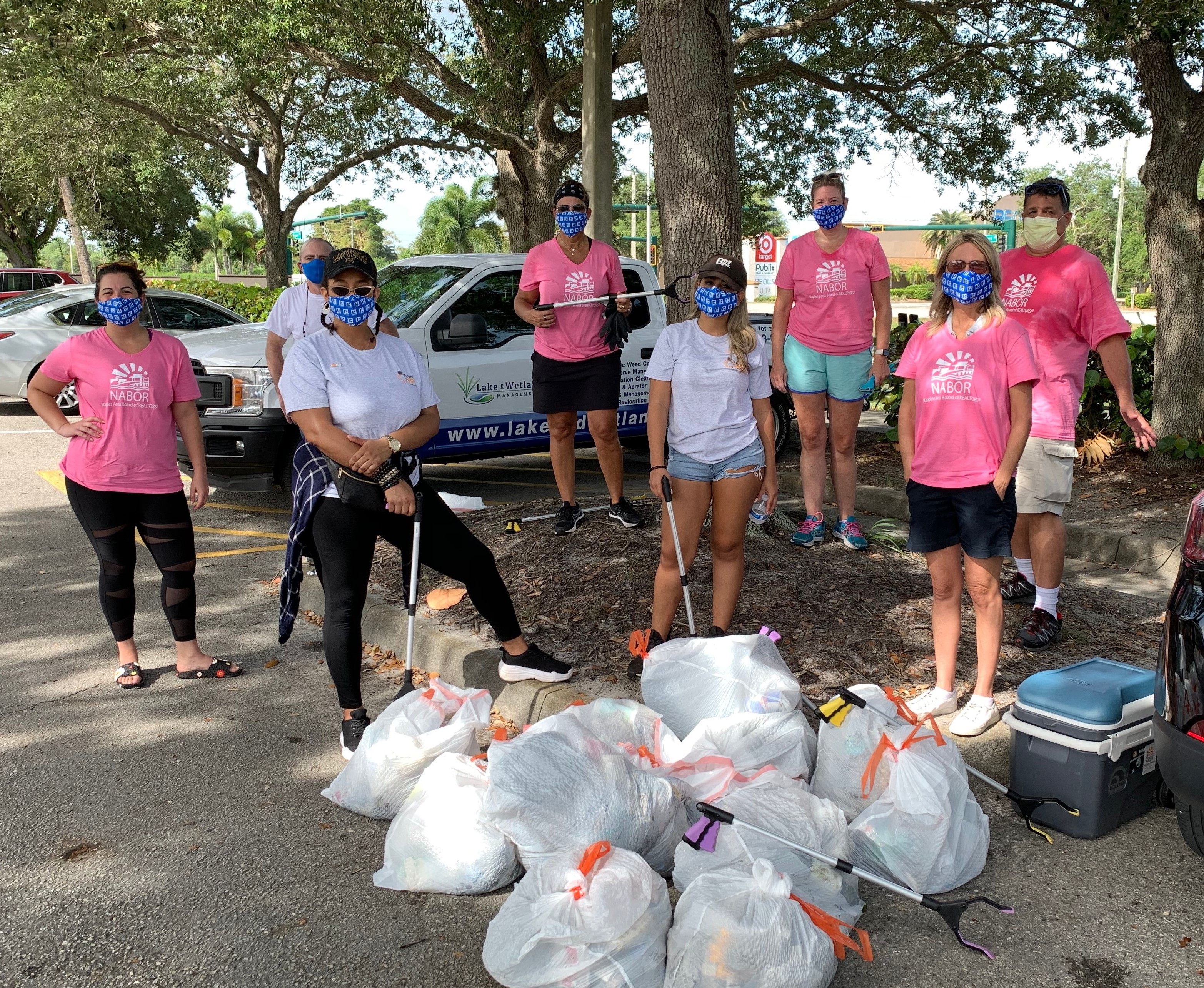 People standing in front of all the trash collected